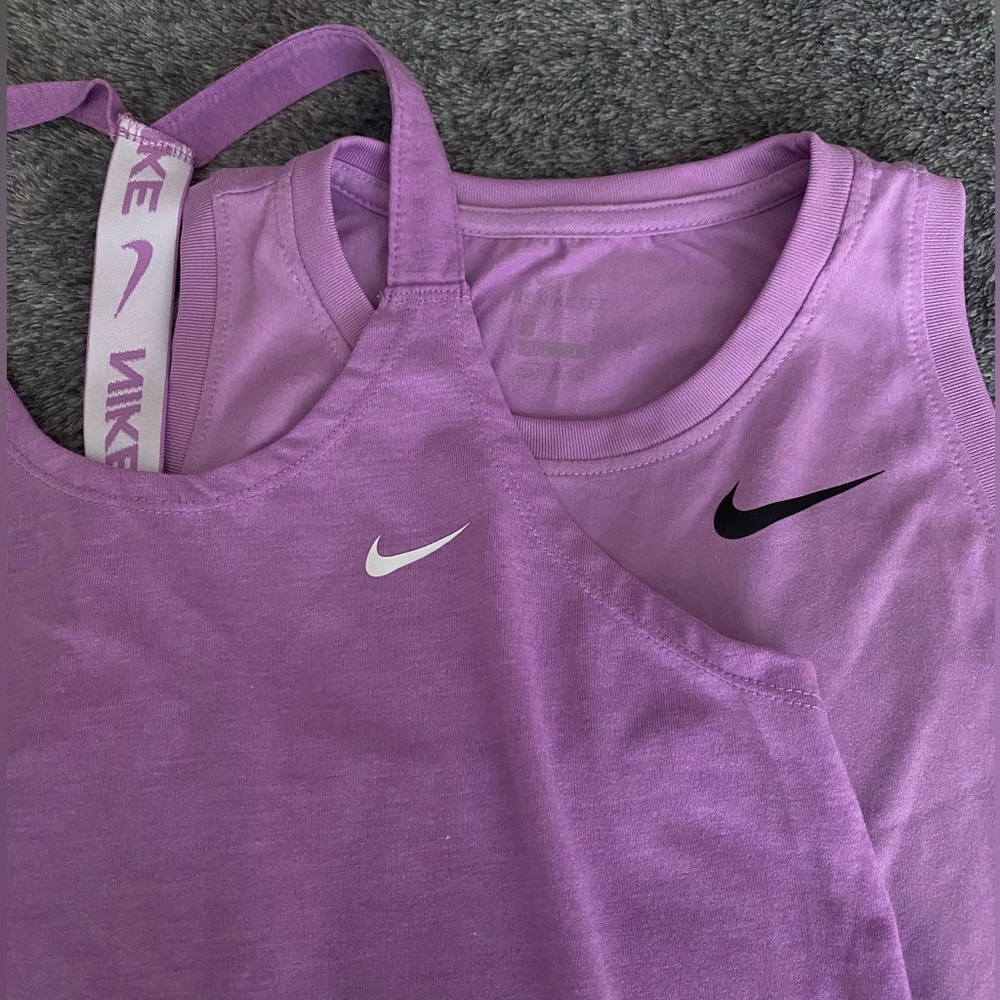 Two purple nike workout tops